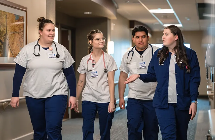 A group of nursing students walk and talk.